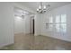 Open concept living room with tile flooring, a window and multiple entryways at 17303 N 98Th Pl, Scottsdale, AZ 85255