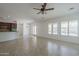 Bright living room with neutral tile flooring, plantation shutters, and modern lighting fixtures at 17303 N 98Th Pl, Scottsdale, AZ 85255