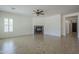 Living room with tile flooring, fireplace, ceiling fan, window and entryways at 17303 N 98Th Pl, Scottsdale, AZ 85255