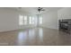 Spacious living room featuring tile floors, fireplace, and abundant natural light from multiple windows at 17303 N 98Th Pl, Scottsdale, AZ 85255
