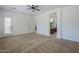 Spacious carpeted main bedroom with ceiling fan, ensuite bathroom, and access to backyard at 17303 N 98Th Pl, Scottsdale, AZ 85255