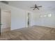 Large main bedroom featuring plush carpet, ceiling fan, and ensuite bathroom entrance at 17303 N 98Th Pl, Scottsdale, AZ 85255