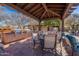 Outdoor kitchen and seating area equipped with grills, perfect for entertaining and dining alfresco at 17303 N 98Th Pl, Scottsdale, AZ 85255