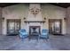 Charming outdoor patio showcases fireplace, seating, and access to manicured garden at 17303 N 98Th Pl, Scottsdale, AZ 85255