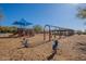 Community playground featuring swings, slides, and spring riders with a shade structure, perfect for outdoor activities at 17303 N 98Th Pl, Scottsdale, AZ 85255