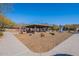 A covered playground area with various play structures, picnic tables, and mature trees, perfect for Gathering fun at 17303 N 98Th Pl, Scottsdale, AZ 85255