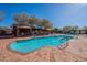 Tranquil swimming pool surrounded by mature trees, cabanas, and lounge chairs for relaxation at 17303 N 98Th Pl, Scottsdale, AZ 85255