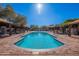 Stunning community pool with poolside cabanas, sun loungers and a pristine, refreshing swimming area at 17303 N 98Th Pl, Scottsdale, AZ 85255