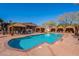 Resort-style pool with covered cabanas, comfortable lounge chairs, and beautifully designed landscaping at 17303 N 98Th Pl, Scottsdale, AZ 85255