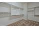 Spacious walk-in closet featuring custom shelving and ample hanging space, ready for organization at 17303 N 98Th Pl, Scottsdale, AZ 85255