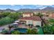 Beautiful aerial view of the property featuring a sparkling pool, putting green, and mountain views at 18500 N 95Th St, Scottsdale, AZ 85255