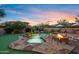 Inviting backyard with a pool, spa, fire pit, and lush landscaping, perfect for relaxation and outdoor gatherings at 18500 N 95Th St, Scottsdale, AZ 85255