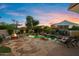 Spacious backyard with a pool, fire pit, lounge chairs, and mature trees, creating a relaxing and inviting outdoor space at 18500 N 95Th St, Scottsdale, AZ 85255