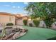 An inviting backyard featuring a putting green, a rock waterfall spa, and mature landscaping at 18500 N 95Th St, Scottsdale, AZ 85255