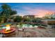 Enjoy a backyard oasis with a gorgeous pool, rock waterfall, and a cozy fire pit for outdoor gatherings at 18500 N 95Th St, Scottsdale, AZ 85255