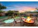 Relax and unwind in this backyard featuring a custom pool, spa, and a charming fire pit area, perfect for entertaining at 18500 N 95Th St, Scottsdale, AZ 85255