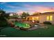 Beautiful backyard with a uniquely shaped pool, mature landscaping, and a cozy fire pit sitting area at 18500 N 95Th St, Scottsdale, AZ 85255