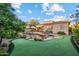Expansive backyard featuring a pool, a putting green, and lush landscaping, perfect for outdoor enjoyment and recreation at 18500 N 95Th St, Scottsdale, AZ 85255