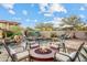 Wonderful backyard showcasing a sparkling pool with a rock waterfall and inviting lounge area with fire pit at 18500 N 95Th St, Scottsdale, AZ 85255