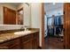 Bathroom with beautiful wood cabinets and countertops with a view of a walk-in closet at 18500 N 95Th St, Scottsdale, AZ 85255