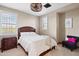 Neutral bedroom with ceiling fan, bed, and window view at 18500 N 95Th St, Scottsdale, AZ 85255