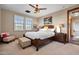Neutral bedroom with a bed, wood furniture, and natural light from windows at 18500 N 95Th St, Scottsdale, AZ 85255