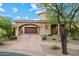 Exterior elevation shows a two-story home with a barrel tile roof and an arched portico in daylight at 18500 N 95Th St, Scottsdale, AZ 85255