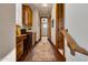 Hallway features a built-in desk, wood cabinets, wood flooring, and an area rug at 18500 N 95Th St, Scottsdale, AZ 85255