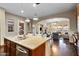 Open-concept kitchen with a granite island, stainless steel sink, and views of the living and dining area at 18500 N 95Th St, Scottsdale, AZ 85255