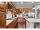 A gourmet kitchen featuring stainless steel appliances, custom cabinetry, and a granite-topped island at 18500 N 95Th St, Scottsdale, AZ 85255