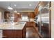 The gourmet kitchen boasts stainless steel appliances, a granite island, and hardwood floors at 18500 N 95Th St, Scottsdale, AZ 85255