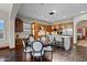 Spacious kitchen with a large island, stainless appliances, and a breakfast area with a round wooden table at 18500 N 95Th St, Scottsdale, AZ 85255