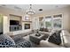 Comfortable living room with a cozy fireplace, large windows with shutter blinds, and stylish seating arrangements at 18500 N 95Th St, Scottsdale, AZ 85255