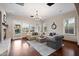 Bright living room featuring hardwood floors, a cozy fireplace, stylish decor, and French doors leading to the backyard at 18500 N 95Th St, Scottsdale, AZ 85255