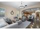 Inviting living room featuring hardwood floors, neutral walls, stylish furniture, and an arched doorway to the kitchen and dining area at 18500 N 95Th St, Scottsdale, AZ 85255