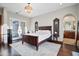 Elegant main bedroom features dark wood furniture, plenty of natural light, and an archway leading to the bathroom at 18500 N 95Th St, Scottsdale, AZ 85255