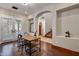 Bright office space with wooden floors, shutters, rustic table and an archway leading to the staircase at 18500 N 95Th St, Scottsdale, AZ 85255