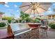 Well-equipped outdoor kitchen with a built-in grill and bar seating, perfect for outdoor cooking and entertaining at 18500 N 95Th St, Scottsdale, AZ 85255