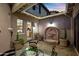 Lovely outdoor patio with a decorative water feature, potted plants, and a comfortable table with seating, ideal for relaxation at 18500 N 95Th St, Scottsdale, AZ 85255