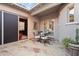 Charming outdoor patio with stone flooring and comfortable seating area, perfect for relaxing and entertaining guests at 18500 N 95Th St, Scottsdale, AZ 85255