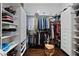 Organized walk-in closet with hardwood floors, custom shelving, and hanging rods provide ample storage at 18500 N 95Th St, Scottsdale, AZ 85255