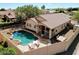 An aerial view of the house featuring the pool, desert landscaping, patio and dining area at 21181 N 80Th Ln, Peoria, AZ 85382