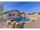 Backyard featuring a refreshing pool, desert landscaping and a view of the home's exterior at 21181 N 80Th Ln, Peoria, AZ 85382