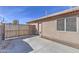 Concrete patio area with partial block wall and back door on a sunny day at 21181 N 80Th Ln, Peoria, AZ 85382