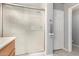 Clean bathroom with a glass-enclosed shower, a towel bar, and a white door at 21181 N 80Th Ln, Peoria, AZ 85382