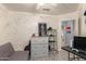 Bedroom with splatter-painted walls, view of ensuite and gray futon at 21181 N 80Th Ln, Peoria, AZ 85382
