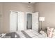 Serene bedroom with ceiling fan, bed and closet with sliding doors at 21181 N 80Th Ln, Peoria, AZ 85382