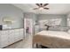 Spacious bedroom with a view of the ensuite bathroom, and a ceiling fan at 21181 N 80Th Ln, Peoria, AZ 85382