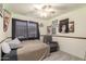 Cozy bedroom with a large window and a comfortable chair. The walls are adorned with posters at 21181 N 80Th Ln, Peoria, AZ 85382