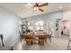 Bright dining room with vaulted ceilings, a ceiling fan, and a large wooden table and bench set at 21181 N 80Th Ln, Peoria, AZ 85382